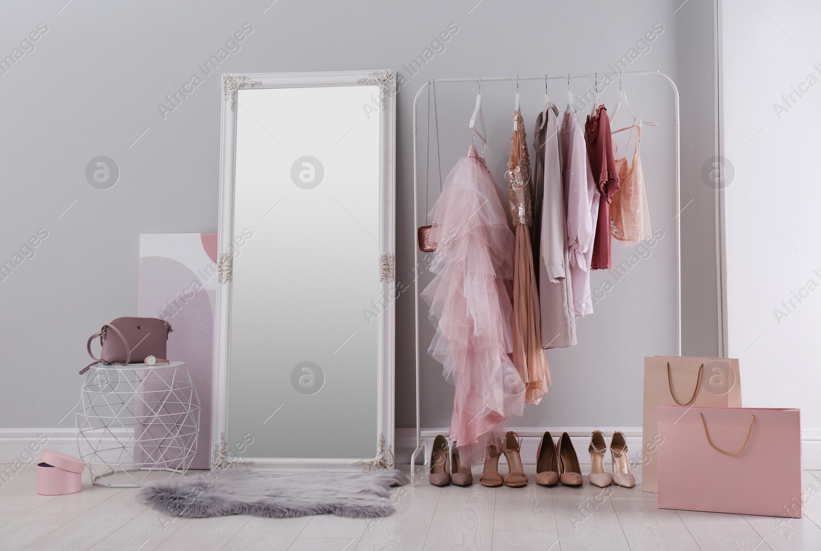 Photo of Modern dressing room interior with clothing rack and mirror