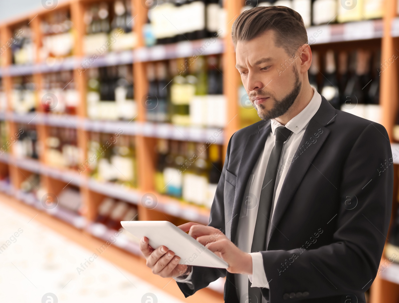 Image of Inspector with tablet in supermarket. Quality control