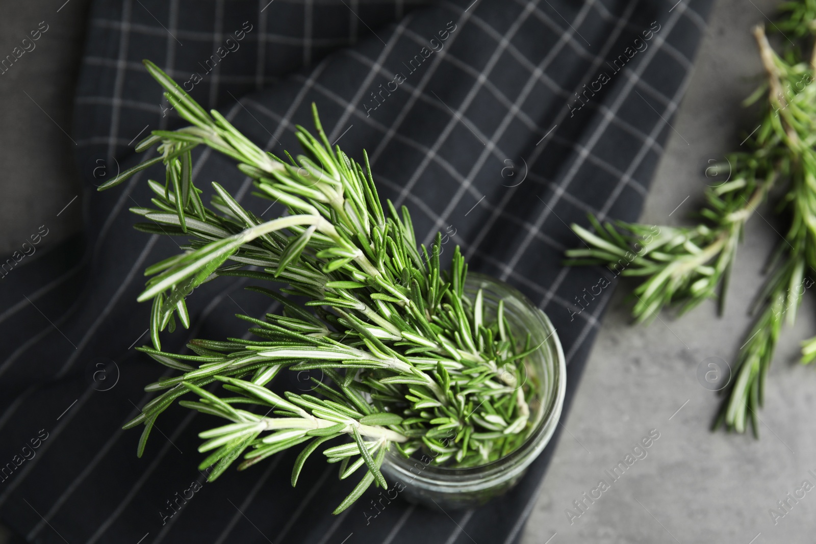 Photo of Fresh green rosemary in jar on table, top view