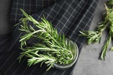 Fresh green rosemary in jar on table, top view