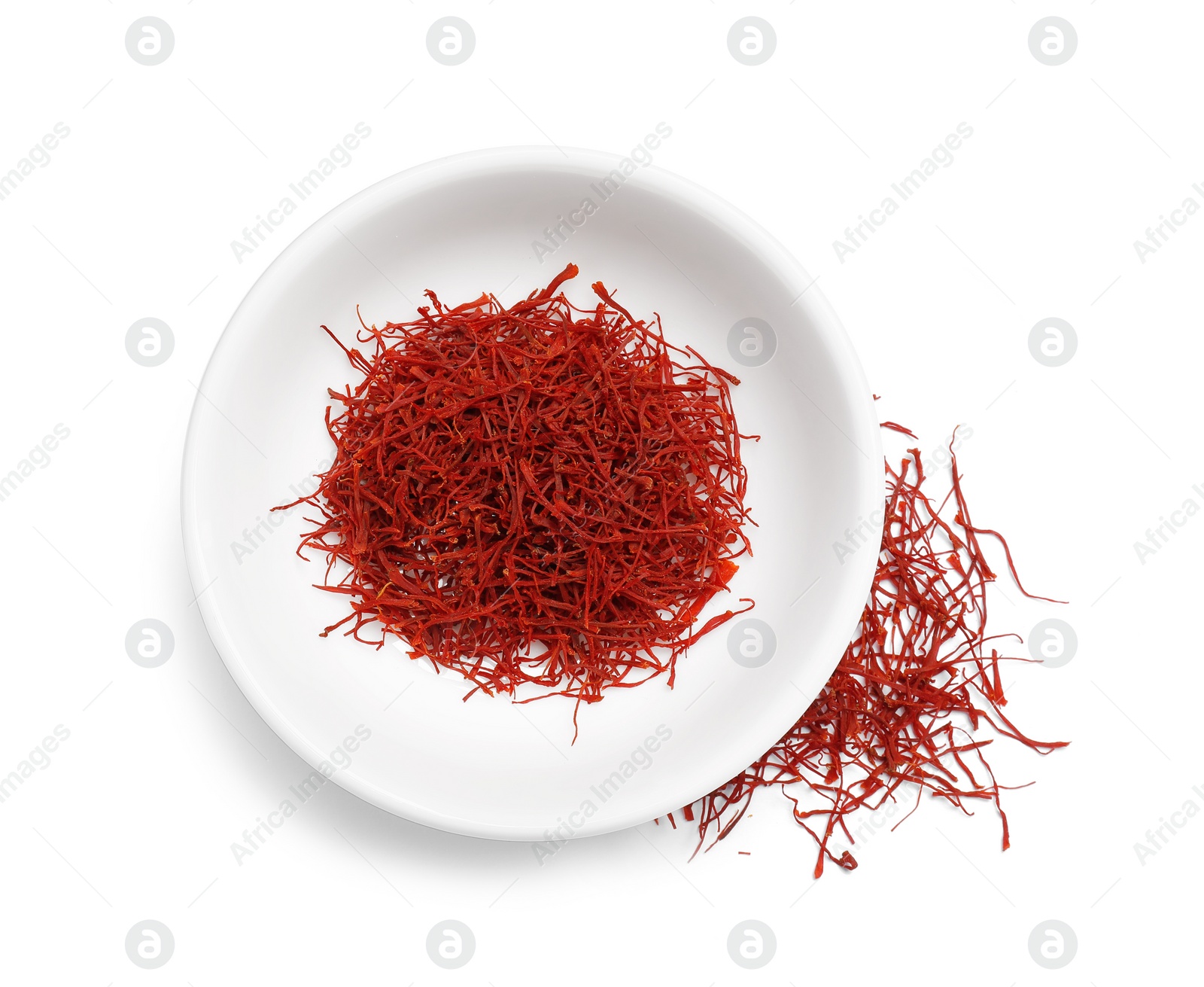 Photo of Aromatic saffron in bowl isolated on white, top view