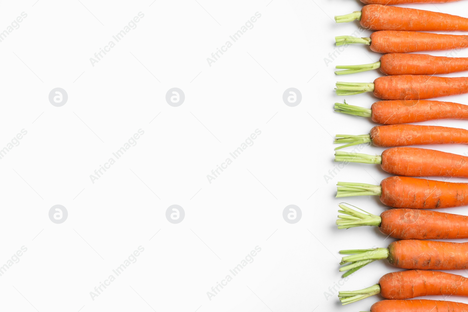 Photo of Ripe carrots isolated on white, top view