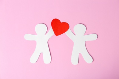 Photo of Paper people with red heart on color background. Romantic feelings