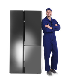 Photo of Professional worker near refrigerator on white background