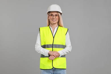 Photo of Engineer in hard hat on grey background