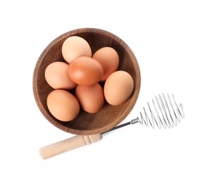Photo of Whisk and bowl with raw eggs isolated on white, top view