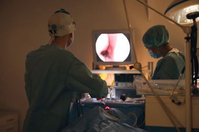 Photo of Professional doctors performing operation in surgery room