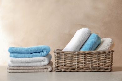 Basket and stack of clean towels on table