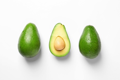 Composition with ripe fresh avocados on white background