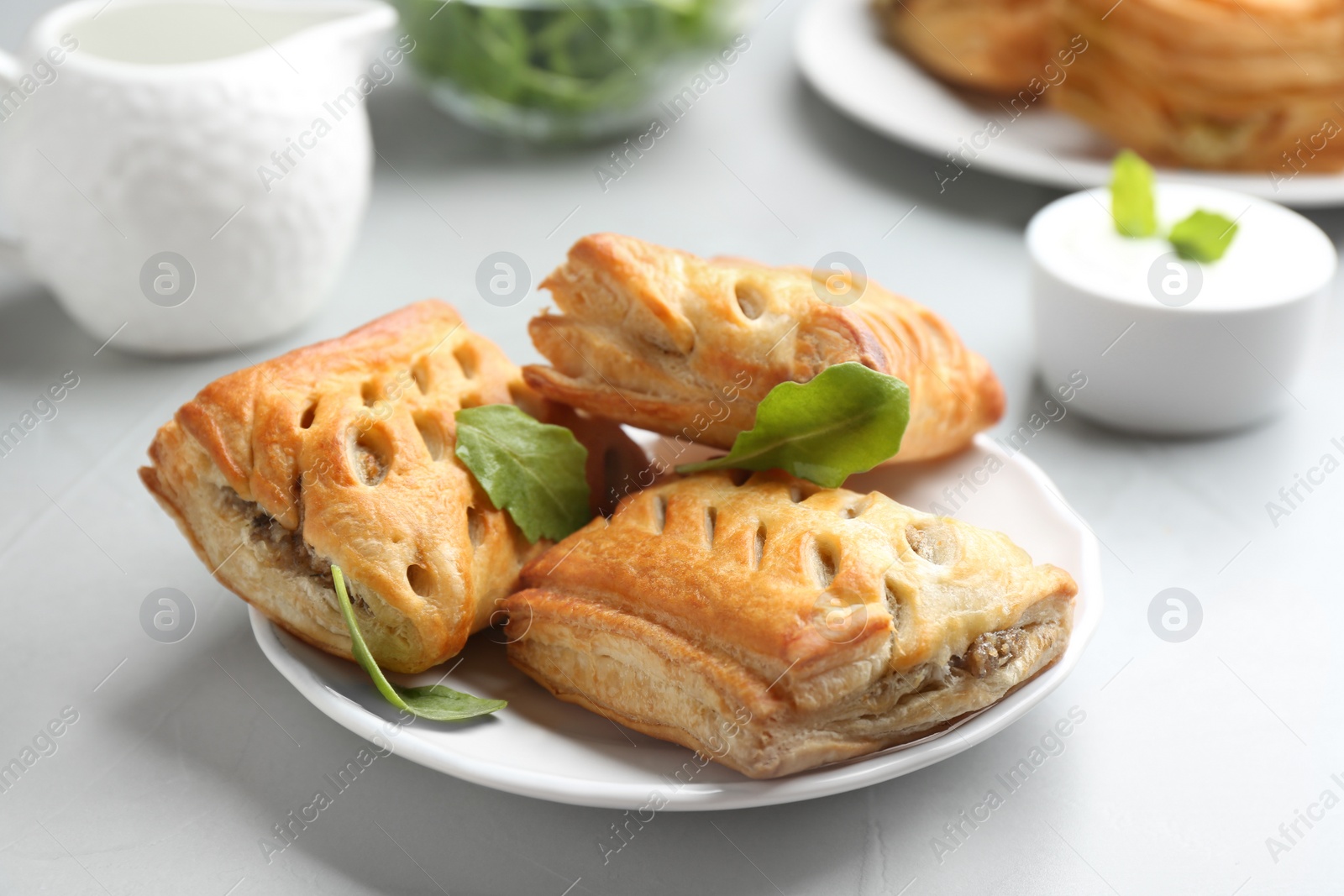 Photo of Fresh delicious puff pastry served on light table