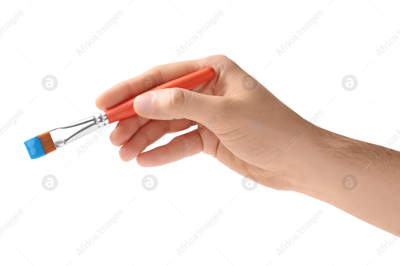 Photo of Young man holding brush with color paint on white background, closeup