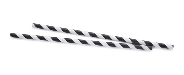 Photo of Striped paper cocktail straws on white background, top view