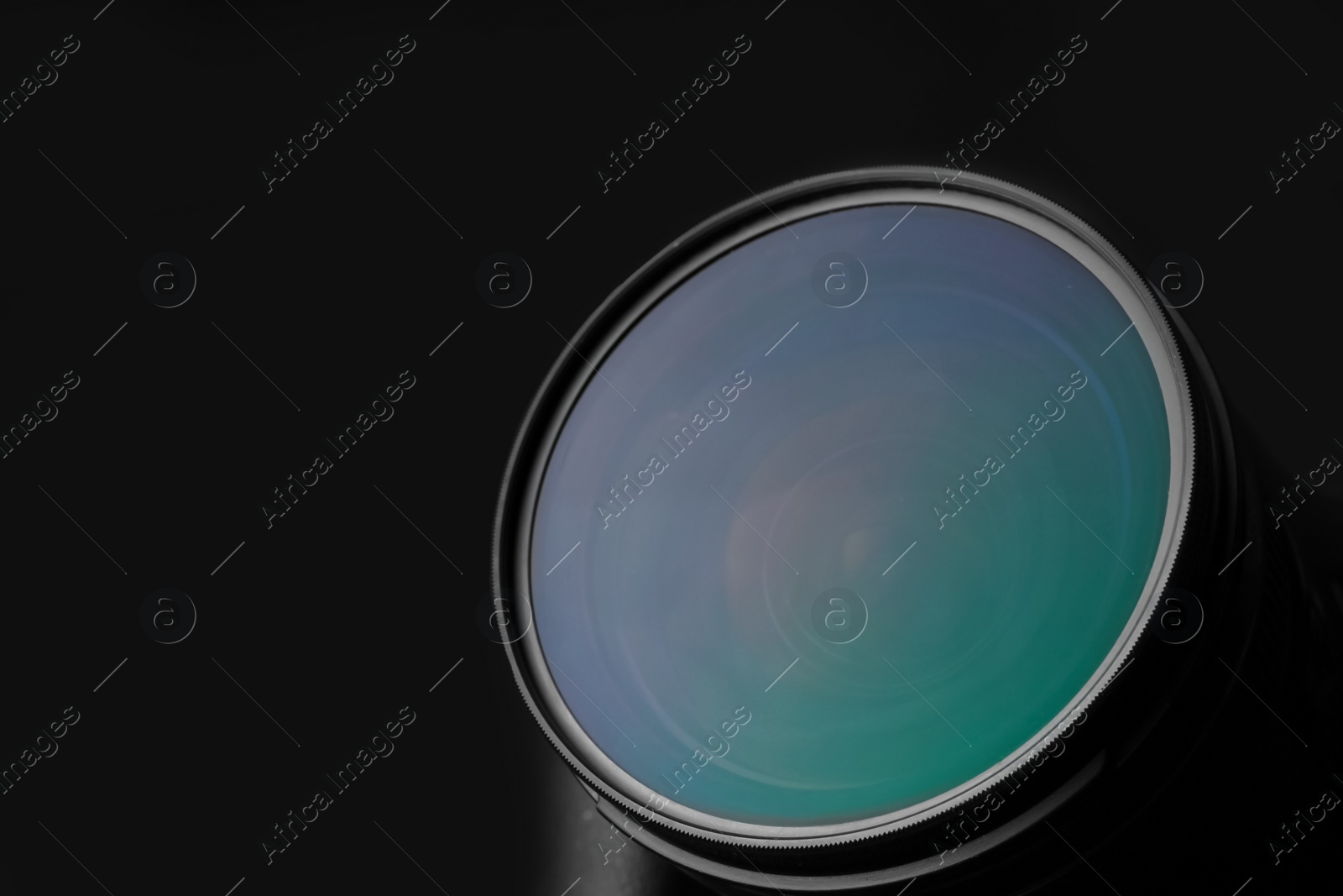 Photo of Modern camera on dark background, closeup of lens. Space for text