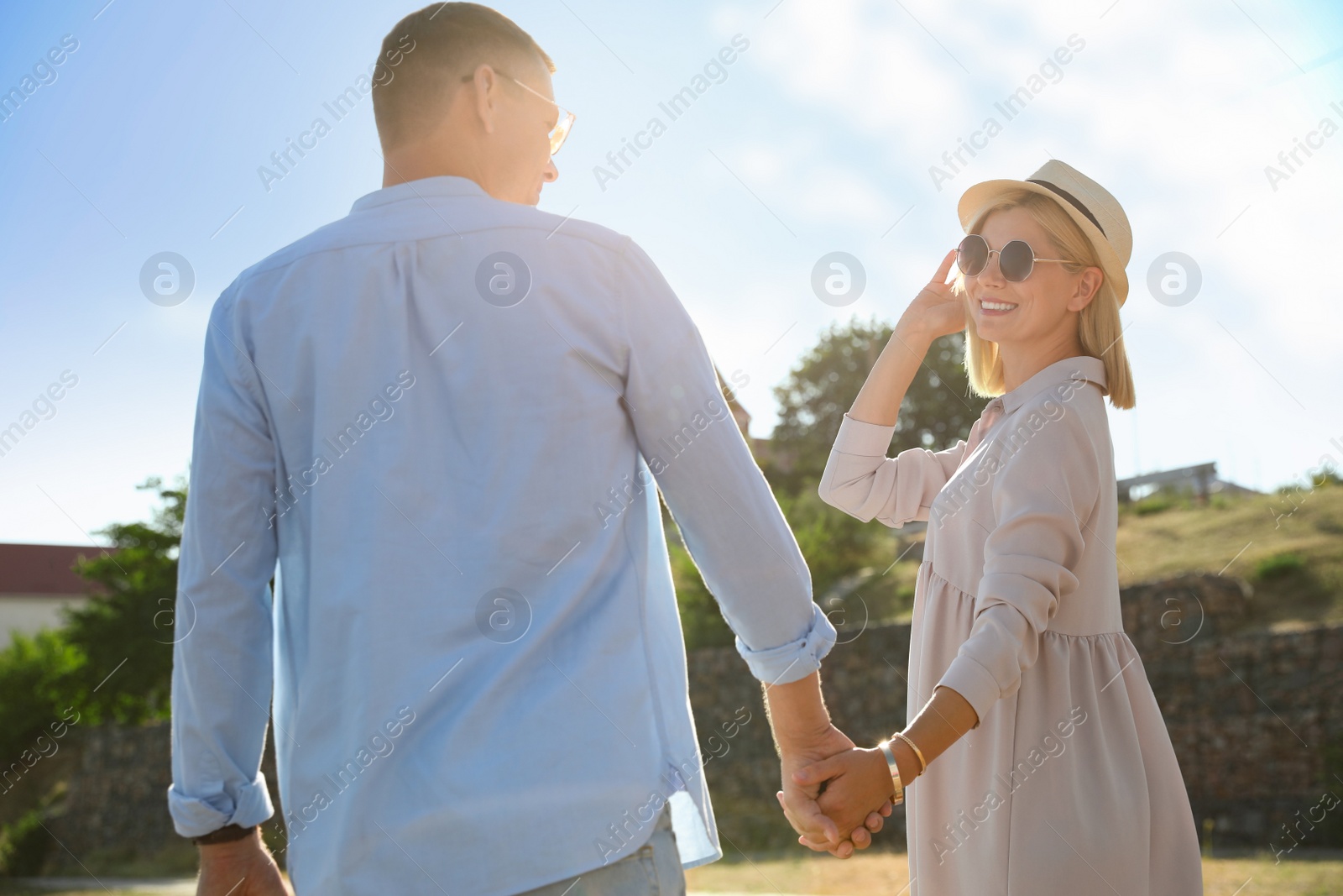 Photo of Happy couple walking outdoors on summer day