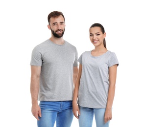 Photo of Young couple in t-shirts on white background. Mockup for design