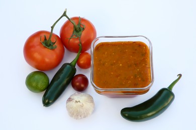 Delicious salsa sauce and ingredients on white background, above view