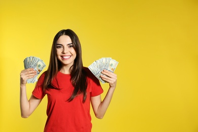 Photo of Young woman with money on color background. Space for text