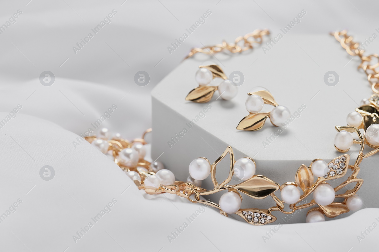 Photo of Beautiful necklace and earrings on white background. Luxury jewelry