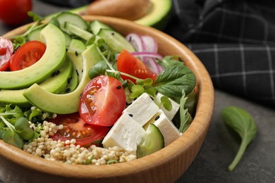 Photo of Delicious avocado salad with quinoa on grey table, closeup