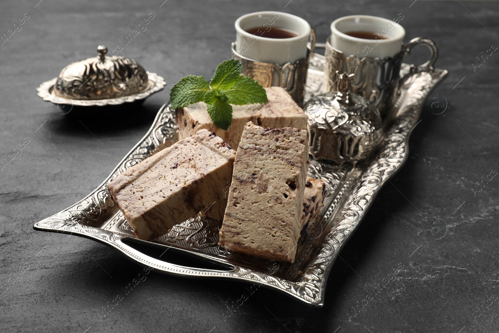 Photo of Tasty chocolate halva served on black table