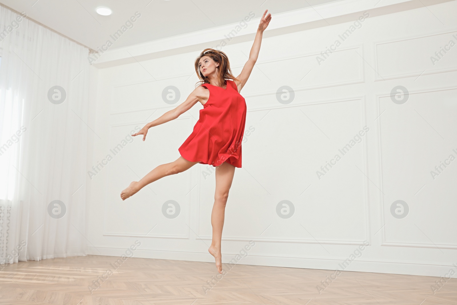 Photo of Beautiful professional dancer practicing moves in studio