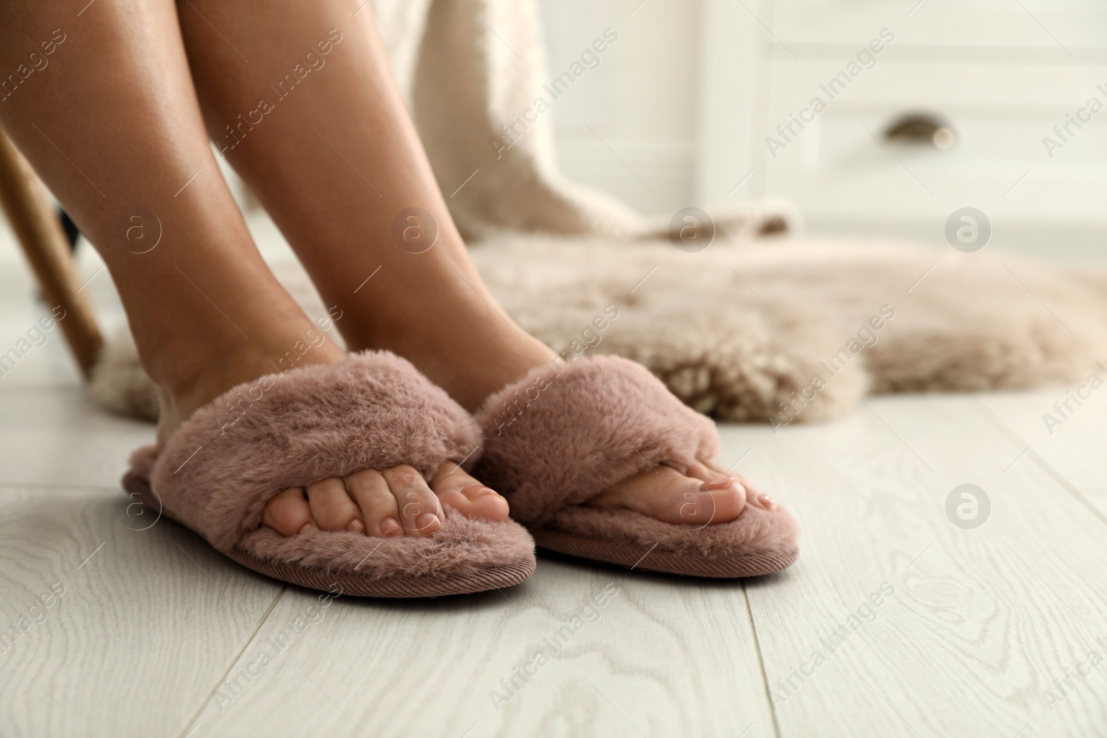 Photo of Woman in fluffy slippers at home, closeup