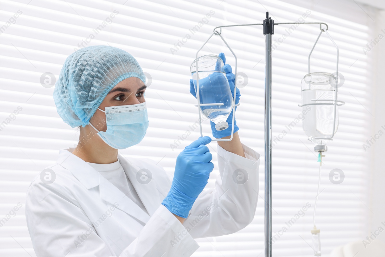 Photo of Nurse setting up IV drip in hospital