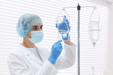 Nurse setting up IV drip in hospital