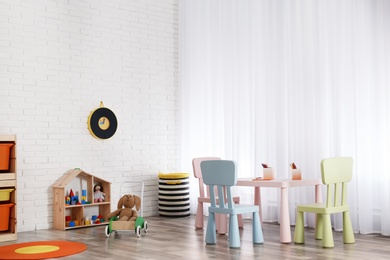 Photo of Modern child room interior with table and chairs