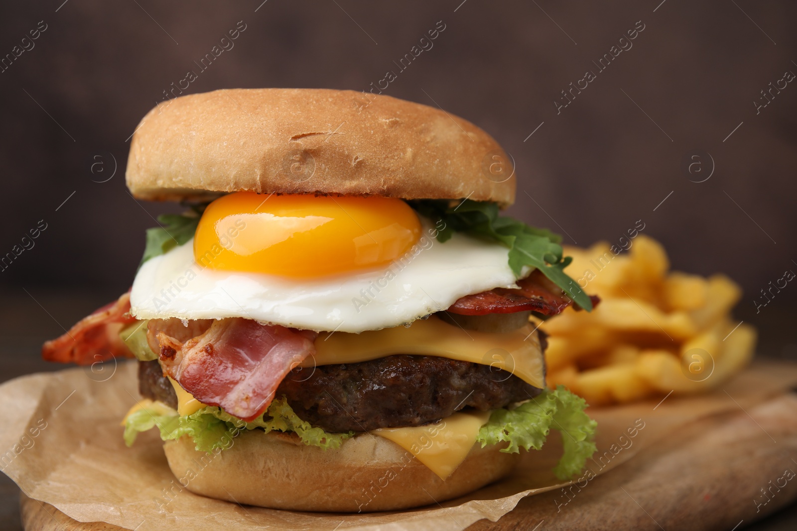 Photo of Delicious burger with fried egg served on table, closeup