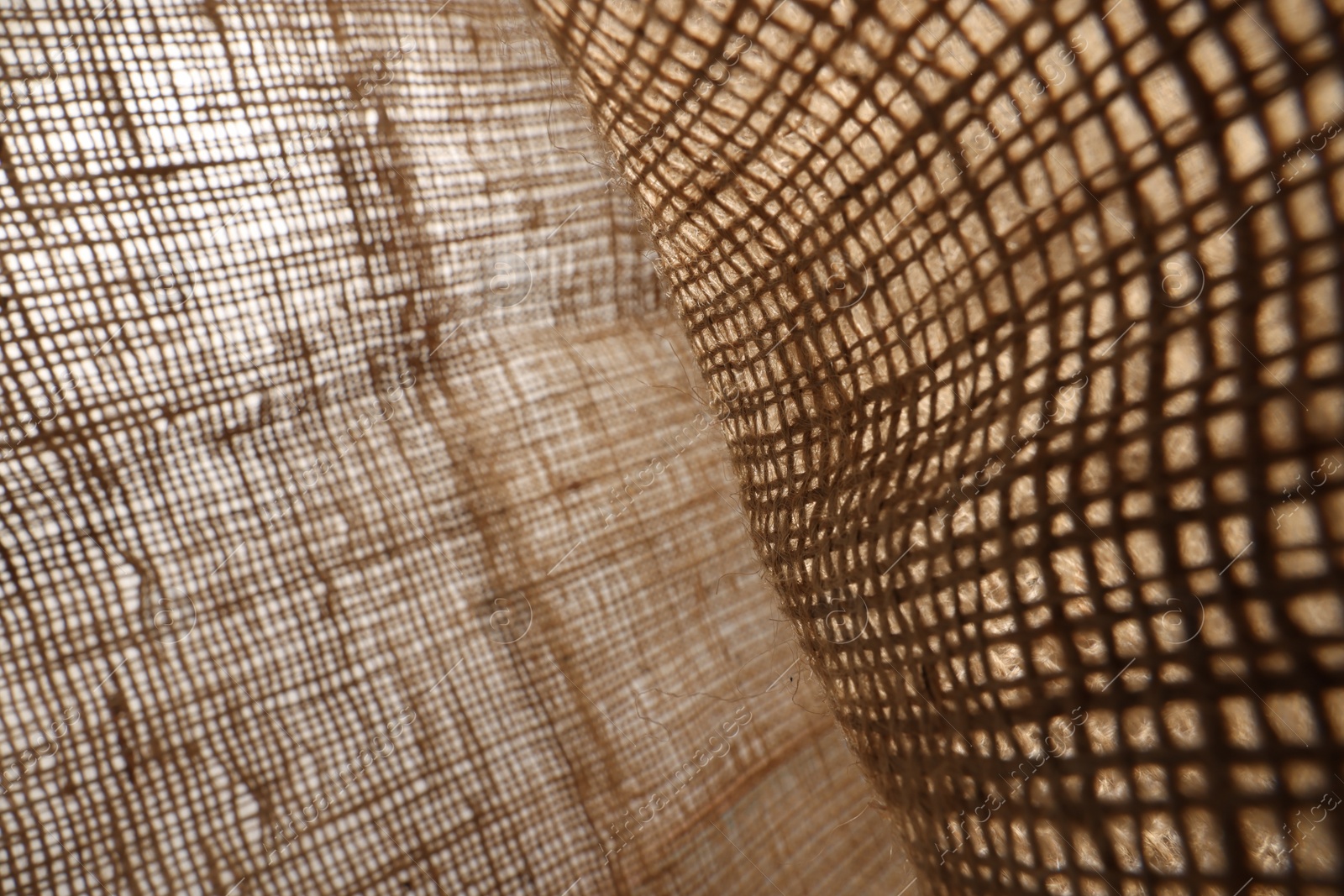 Photo of Texture of natural burlap fabric as background, closeup