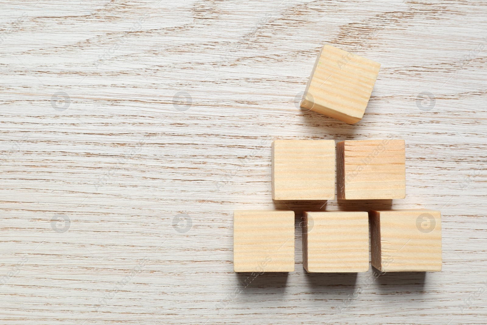 Photo of Blank cubes on white wooden table, flat lay with space for text. Idea concept