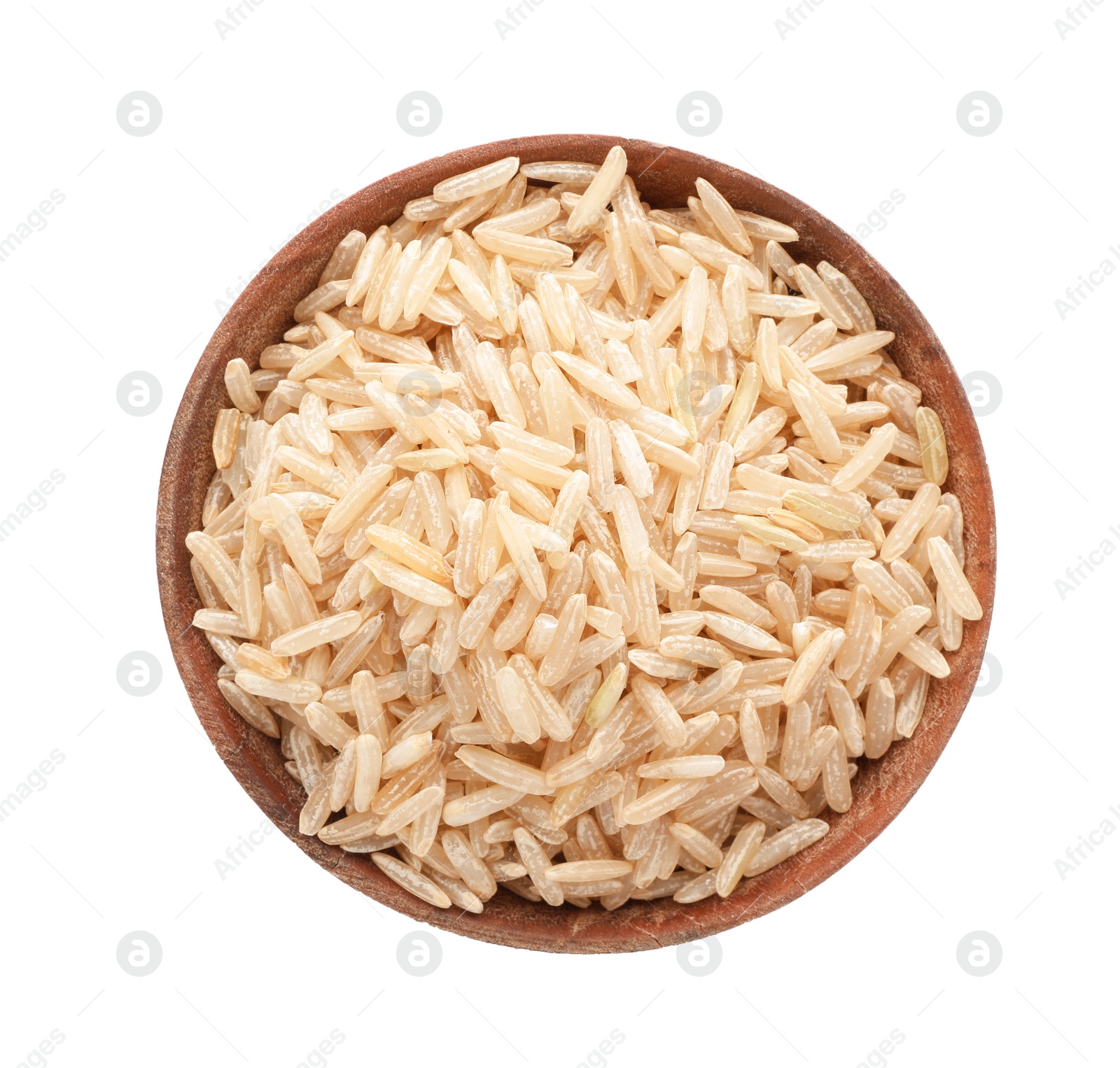 Photo of Wooden bowl with brown rice on white background, top view