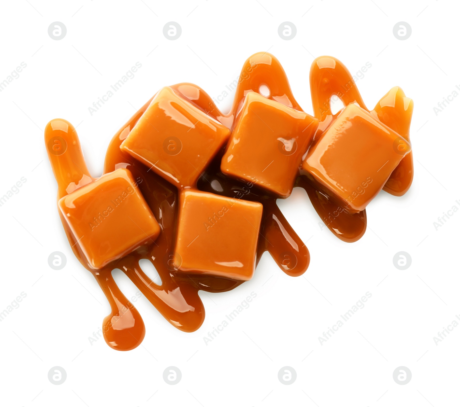 Photo of Caramel candies with topping on white background, top view