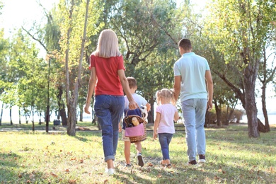 Family with picnic basket in park on sunny day