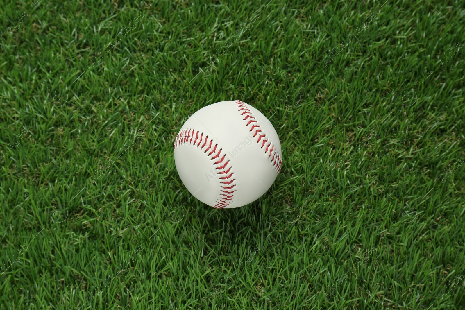Photo of Baseball ball on green grass, top view. Sports game