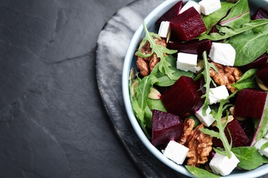 Delicious beet salad served on black table, top view. Space for text