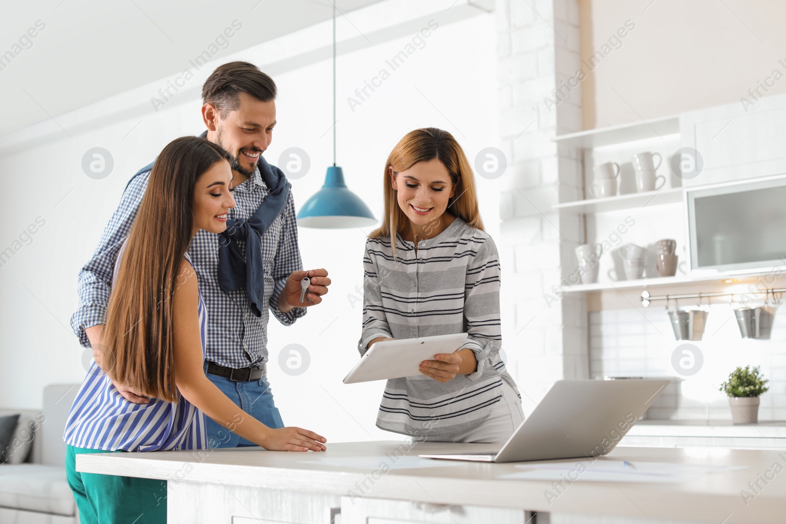 Photo of Female real estate agent working with couple, indoors