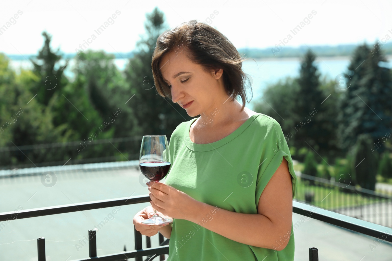 Photo of Woman with glass of red wine outdoors