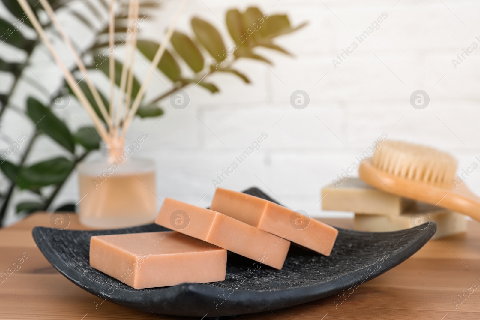 Photo of Plate with handmade soap bars on table