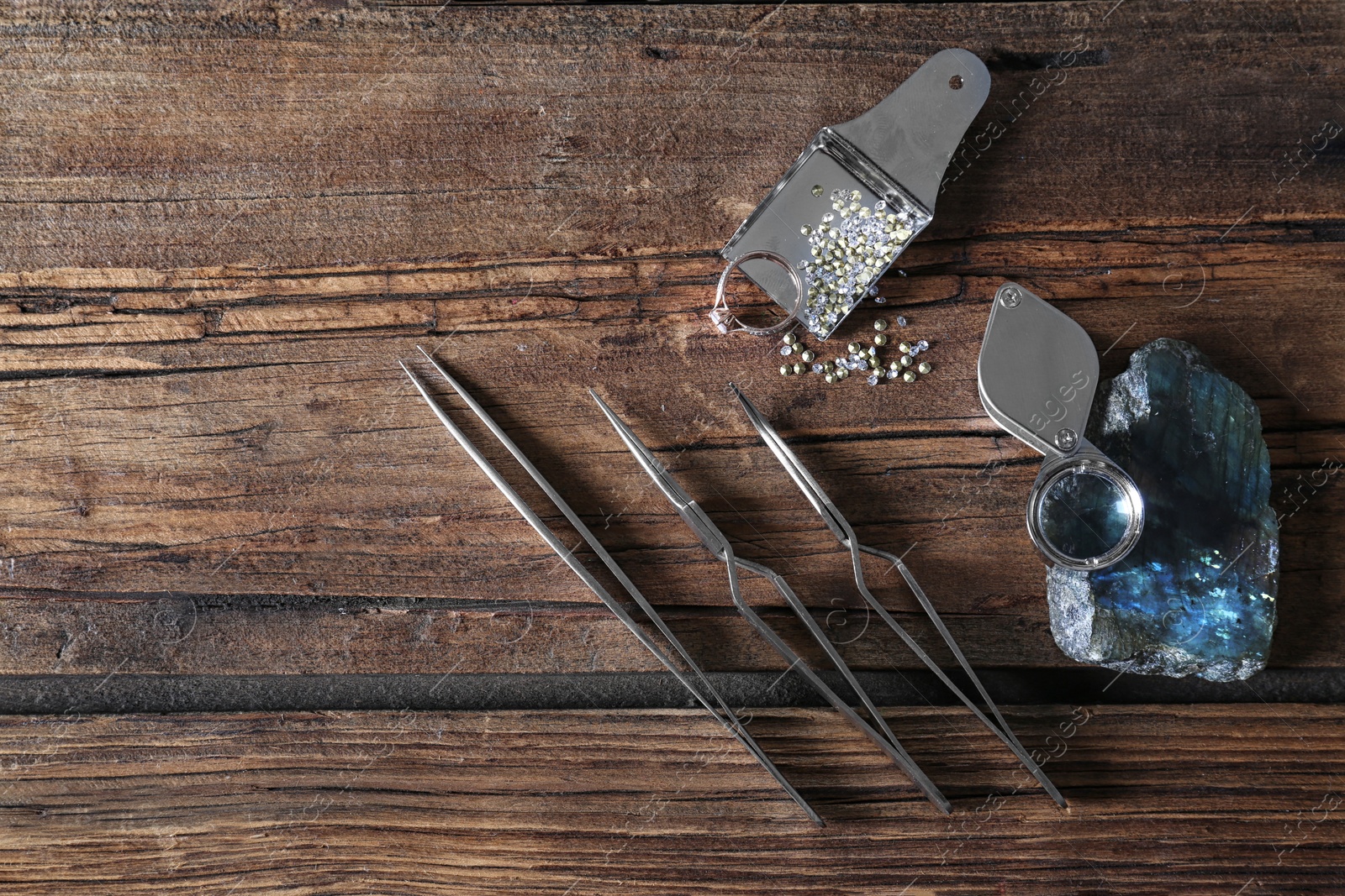Photo of Flat lay composition with jewelry tools on wooden table