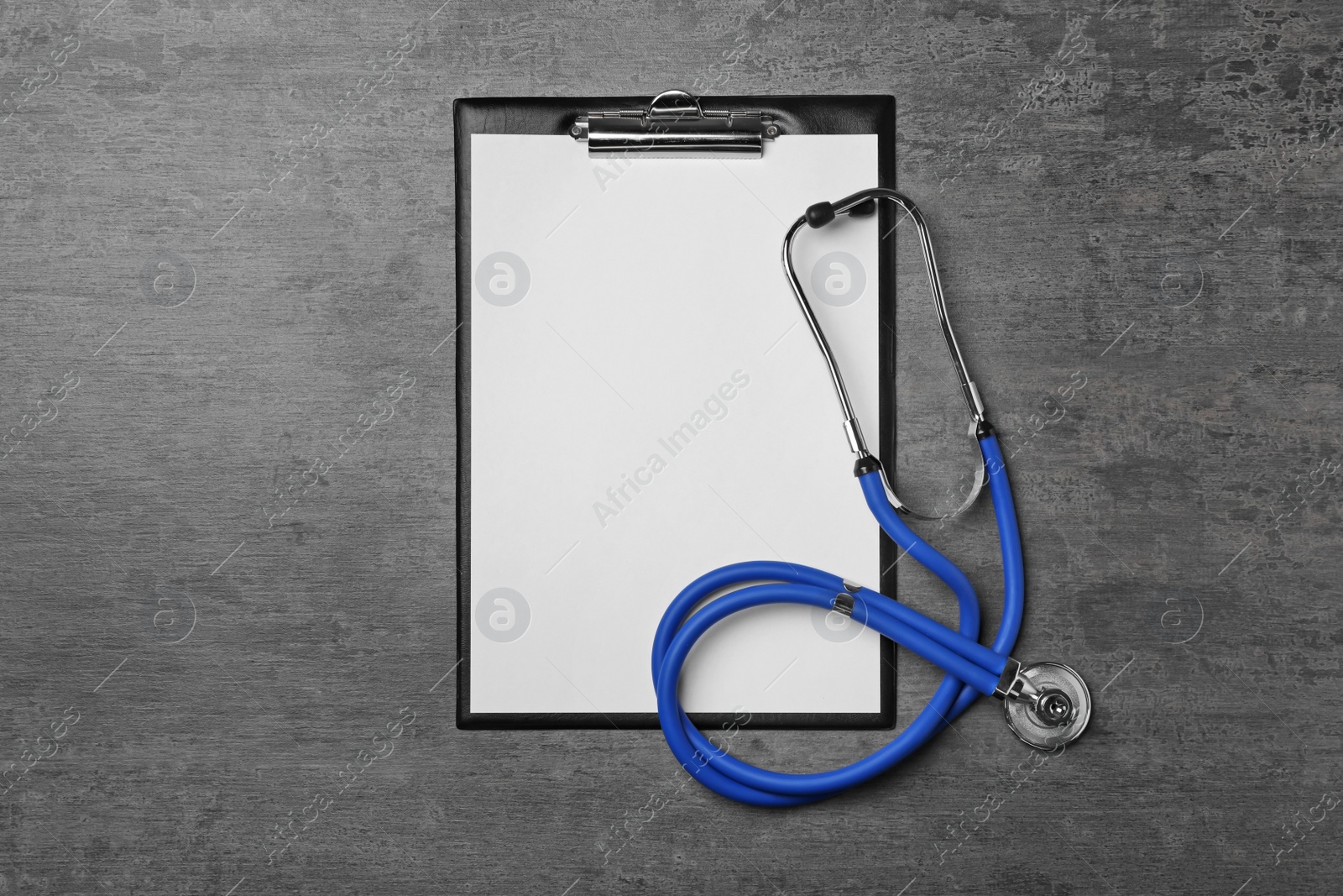 Photo of Clipboard and stethoscope on table. Urology concept