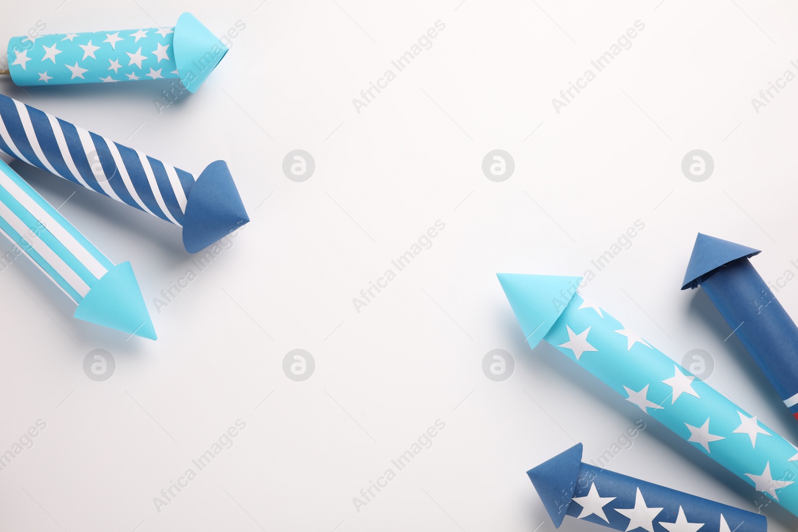 Photo of Firework rockets on white background, above view. Space for text