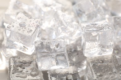 Photo of Melting ice cubes with water drops as background, closeup