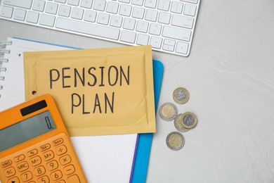 Photo of Envelope with words Pension Plan, coins, calculator and notebook on white office table, flat lay