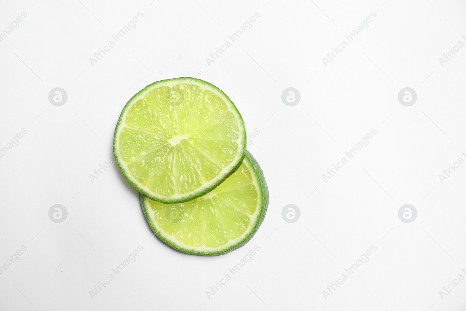 Photo of Slices of fresh juicy lime on white background, top view