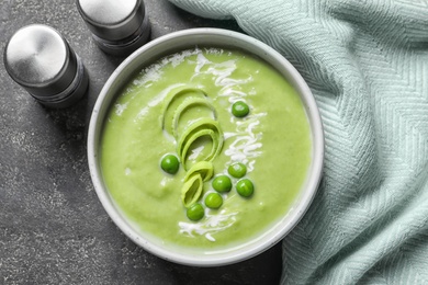 Photo of Fresh vegetable detox soup made of green peas served on table, top view