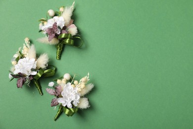 Photo of Stylish boutonniere on green background, flat lay. Space for text