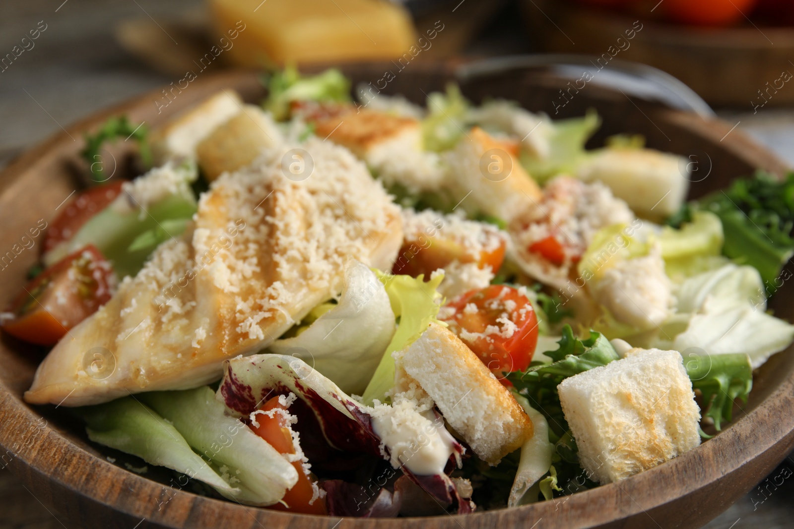 Photo of Delicious Caesar salad in bowl, closeup view