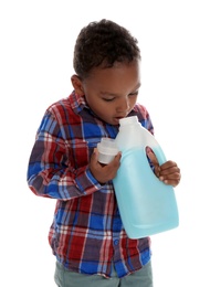 Photo of Little African-American boy playing with detergent on white background. Danger at home